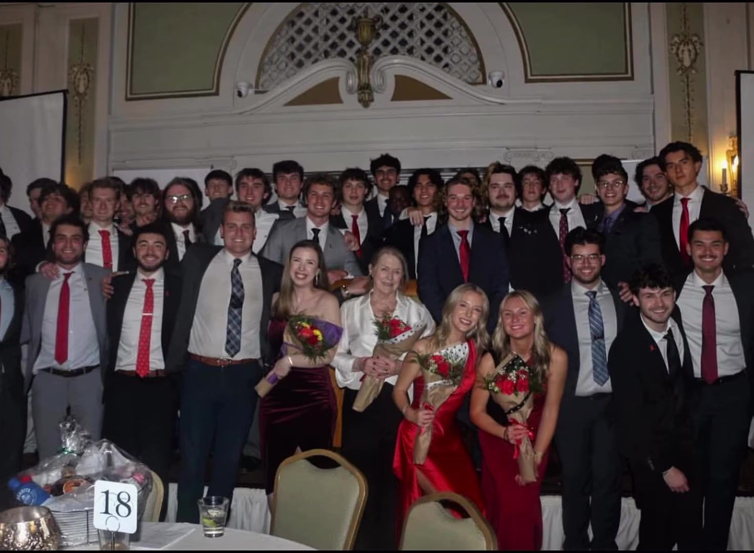 Formal group photo with dates holding roses