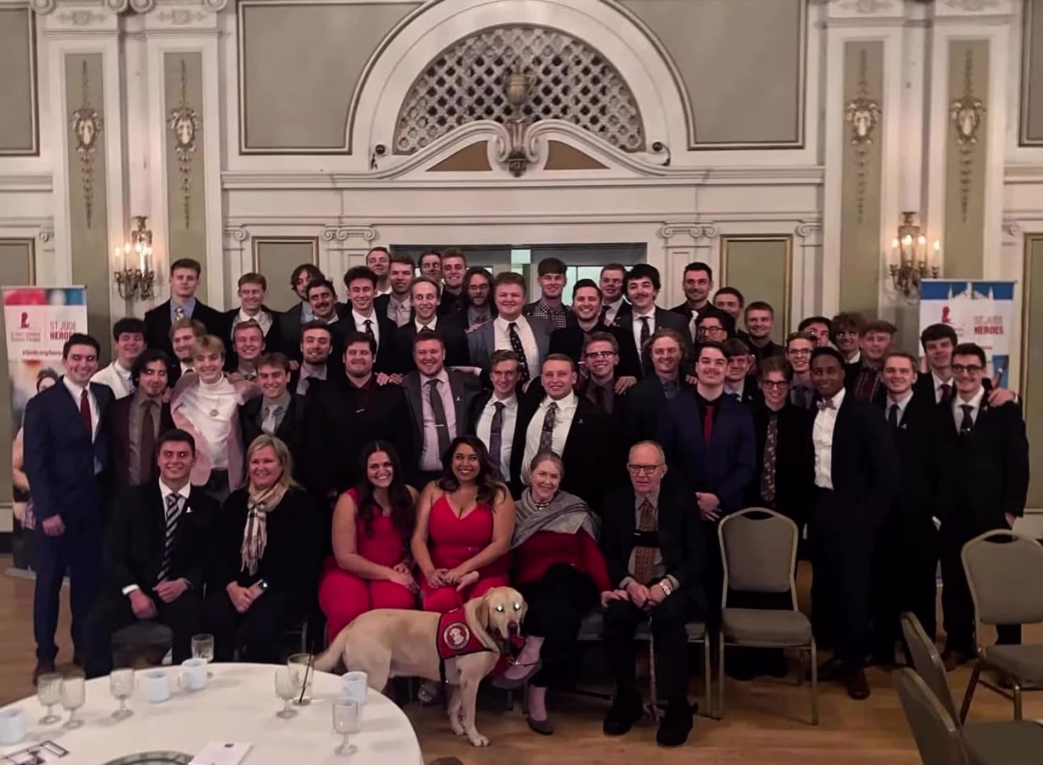 Chapter group photo with honored guests and a St. Jude service dog