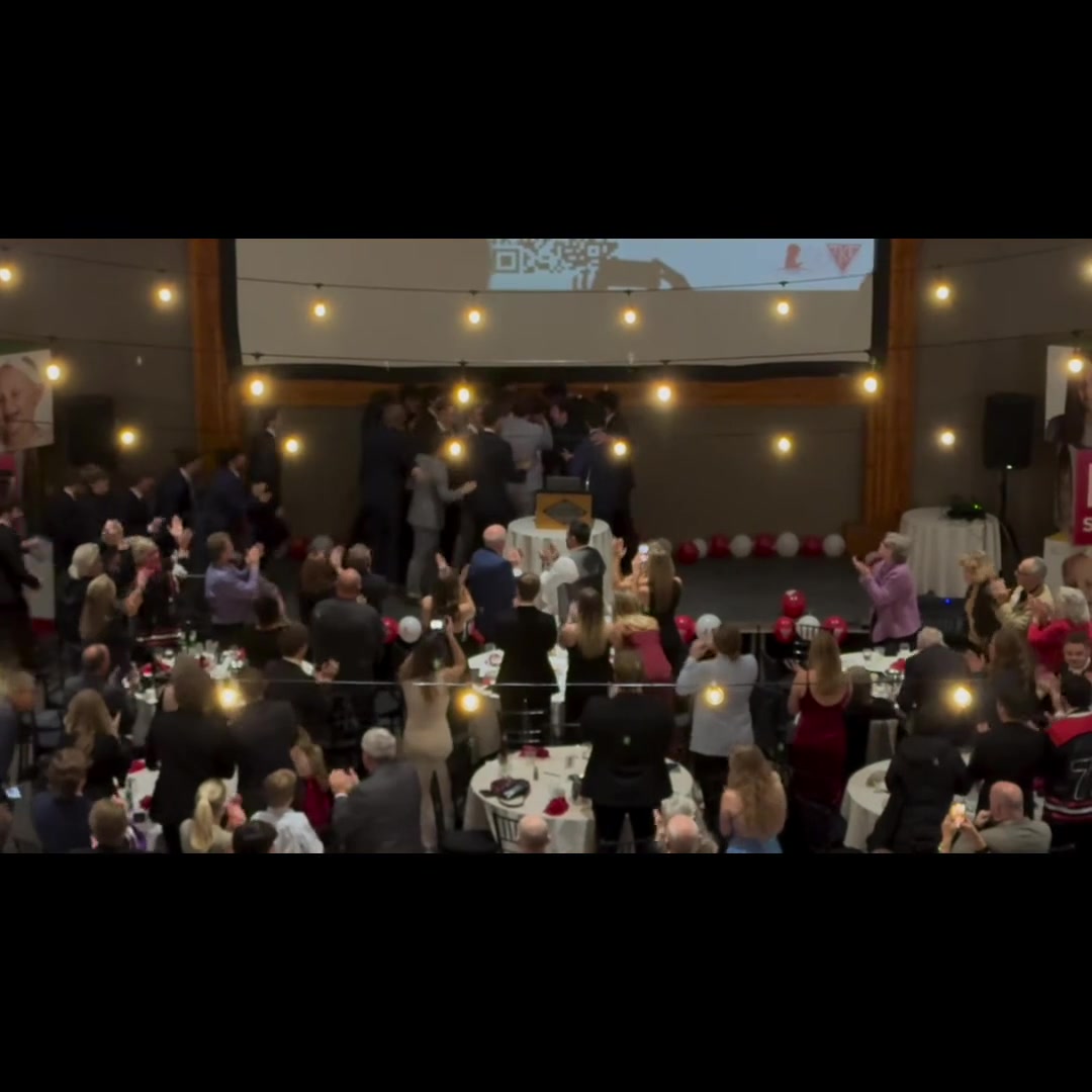 Guests giving a standing ovation during the chapter's speech